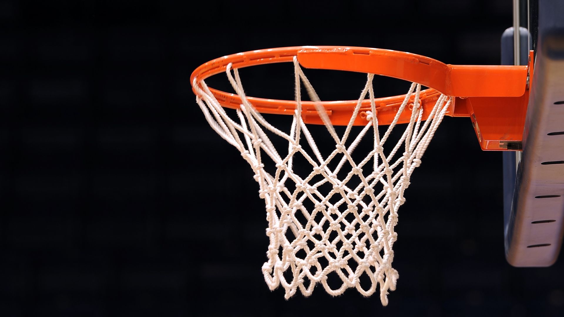 Basketball going through the net in a game