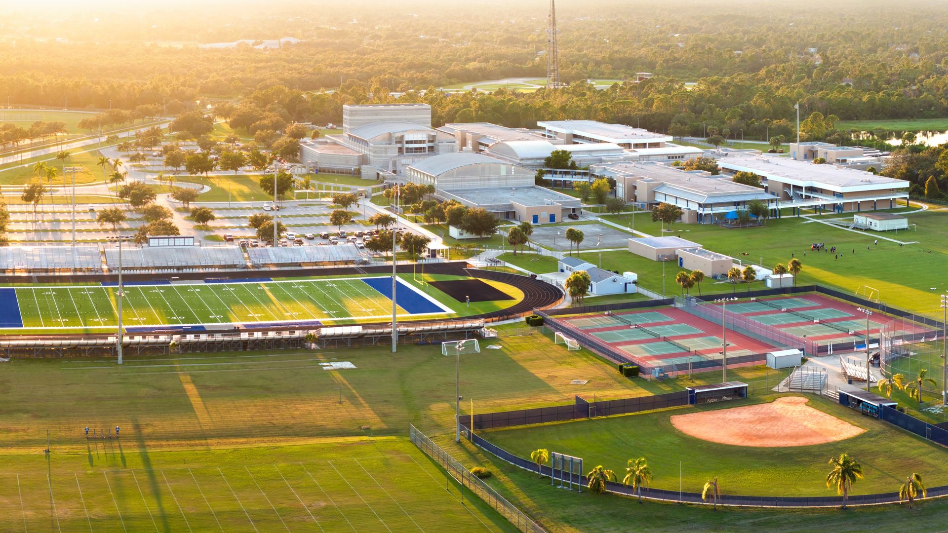 Aerial view of a university campus with athletic facilities and surrounding landscape