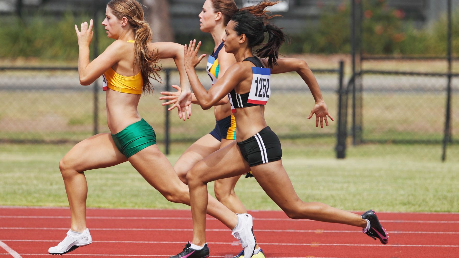 Sprinter launching out of starting blocks on a competition track